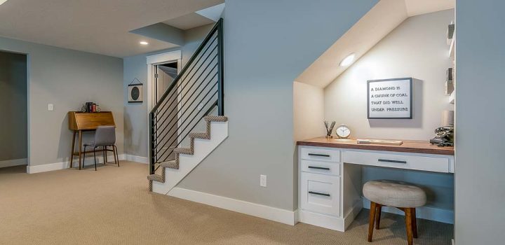 A basement repurposed as a recreation room. Desk used for homework or other school work